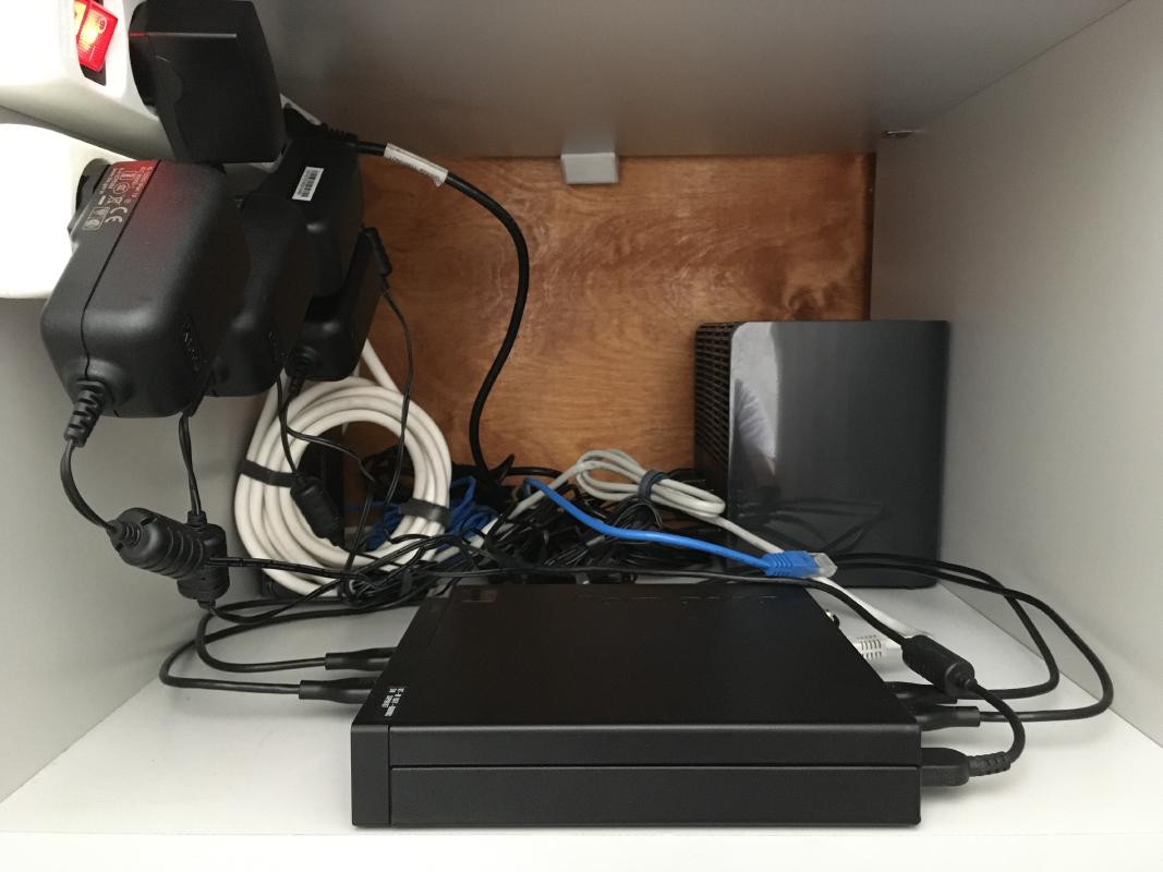 The current setup in all its glory. Don't worry, the cable mess is temporary until I get a PSU that can supply all the drives at once.