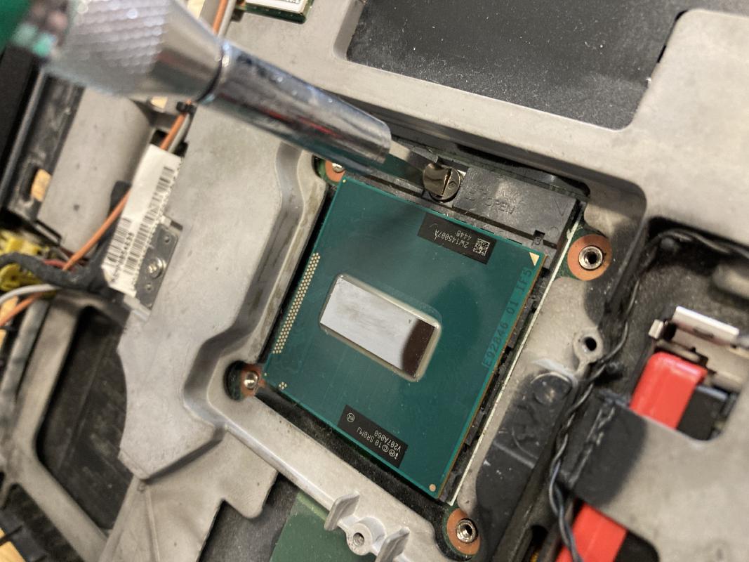 Loosen the CPU by turning the screw with a flathead screwdriver.