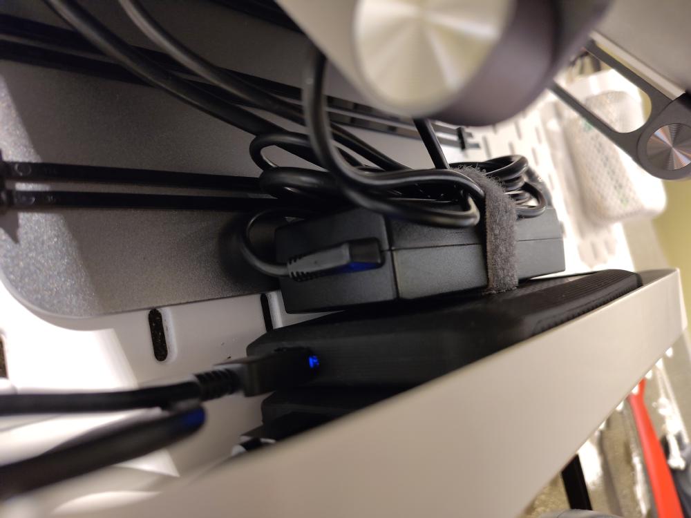 The small shelf attachment holds two external drives and the power adapter.