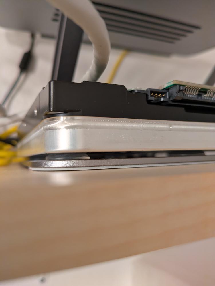 I added glue-on rubber feet on the stand to make sure the drives do not accidentally slip off anywhere. It does nothing
to reduce the noise, though, and I'm convinced that it's actually making the noise worse.