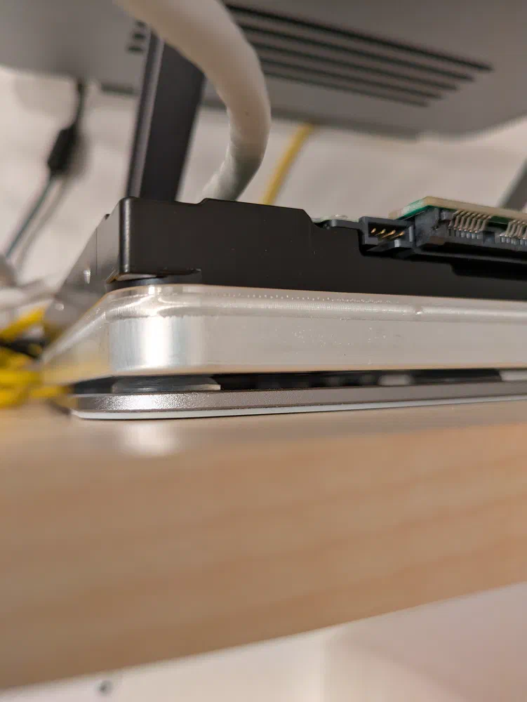 I added glue-on rubber feet on the stand to make sure the drives do not accidentally slip off anywhere. It does nothing
to reduce the noise, though, and I'm convinced that it's actually making the noise worse.