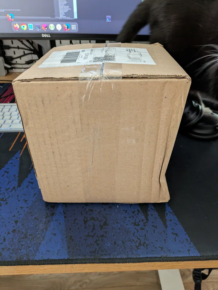 The cardboard box with a slight dent.