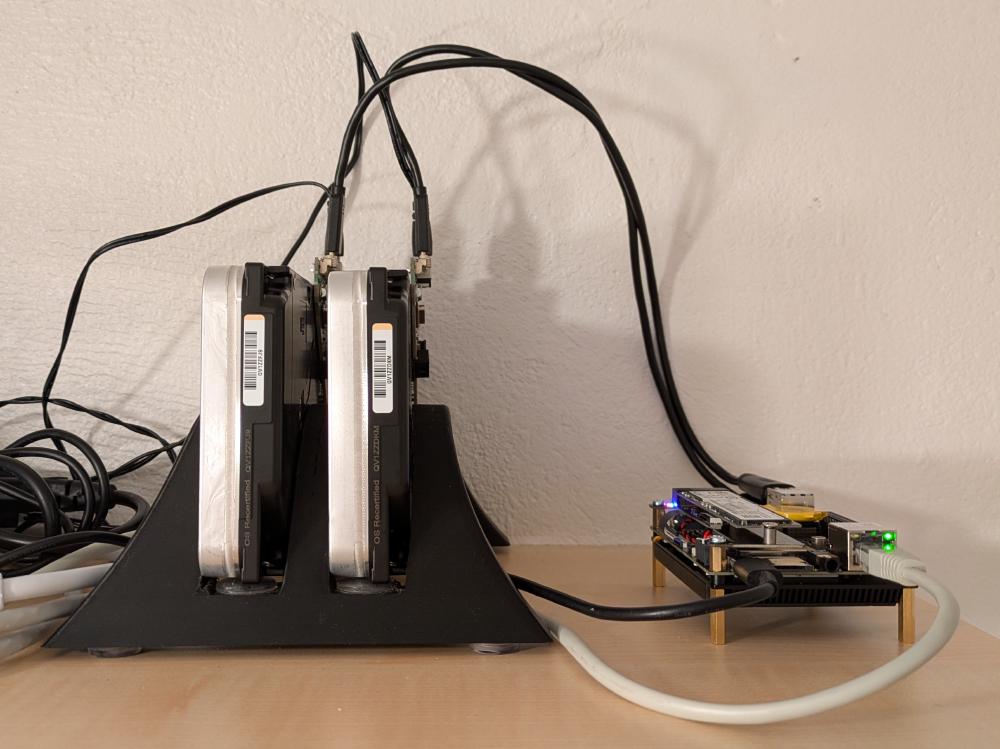 The LattePanda IOTA next to two 18TB hard drives, running as a home server.