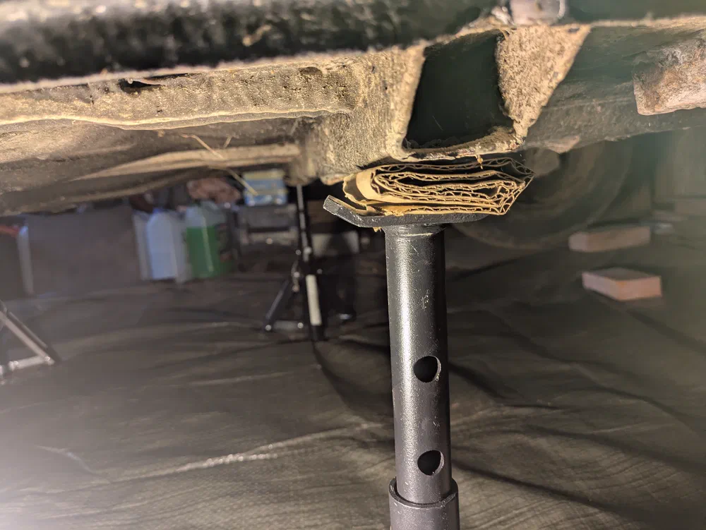 This car has the support of 3 out of 4 axle stands. Really.